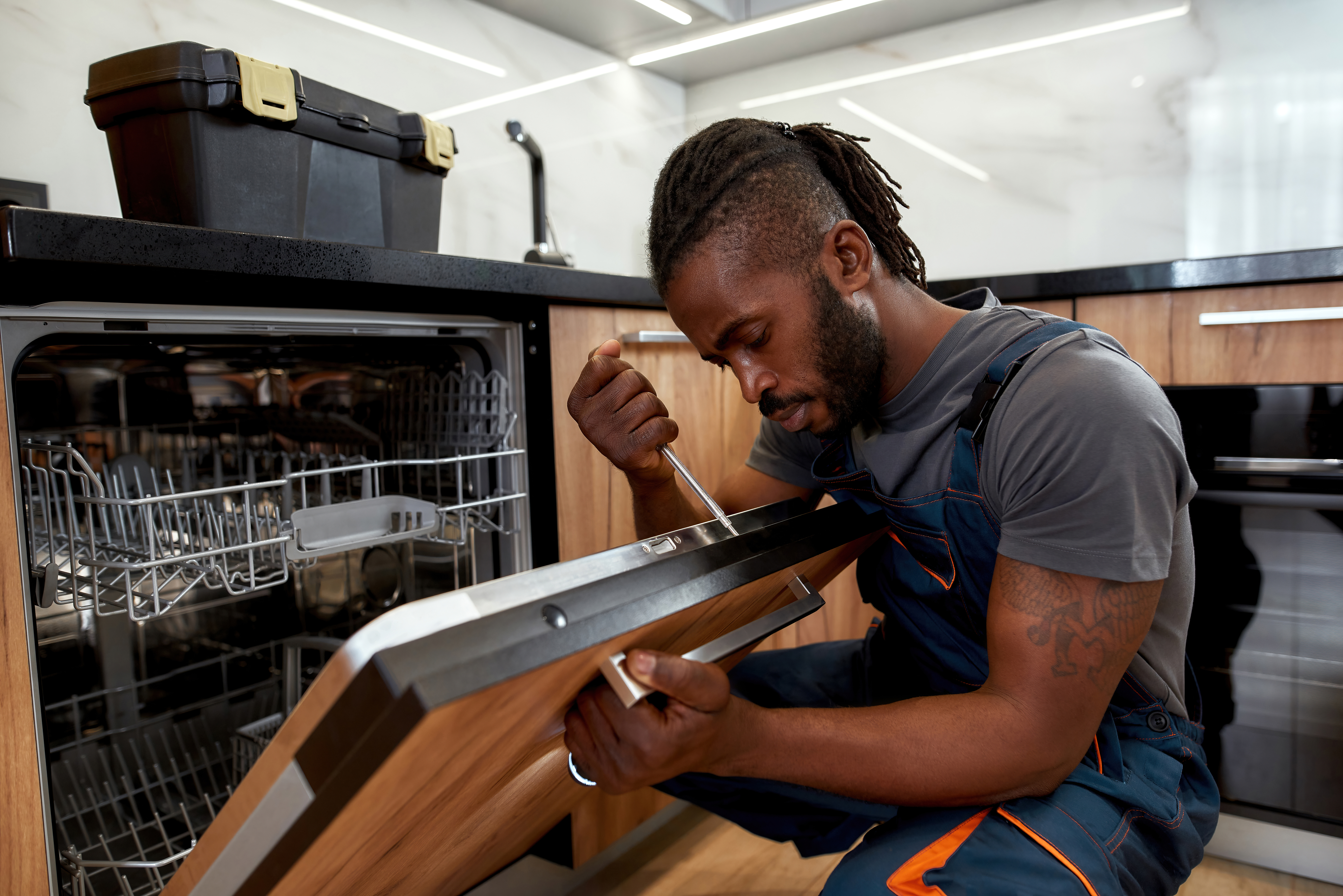 A WyattWorks service pro working on a diswasher installation in Mooresville / Huntersville, NC