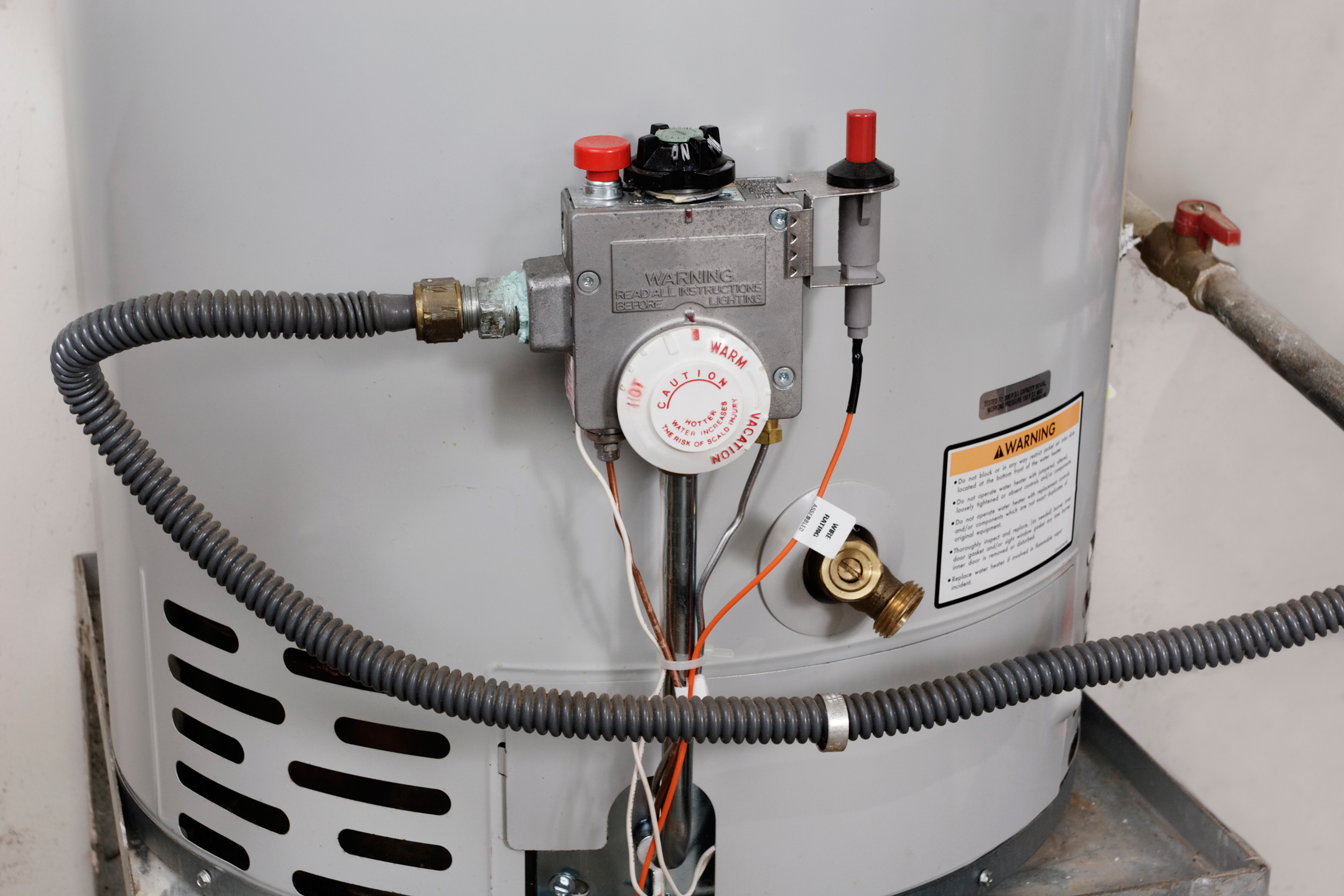 An image of a water heater being serviced by a WyattWorks Plumbing team member.