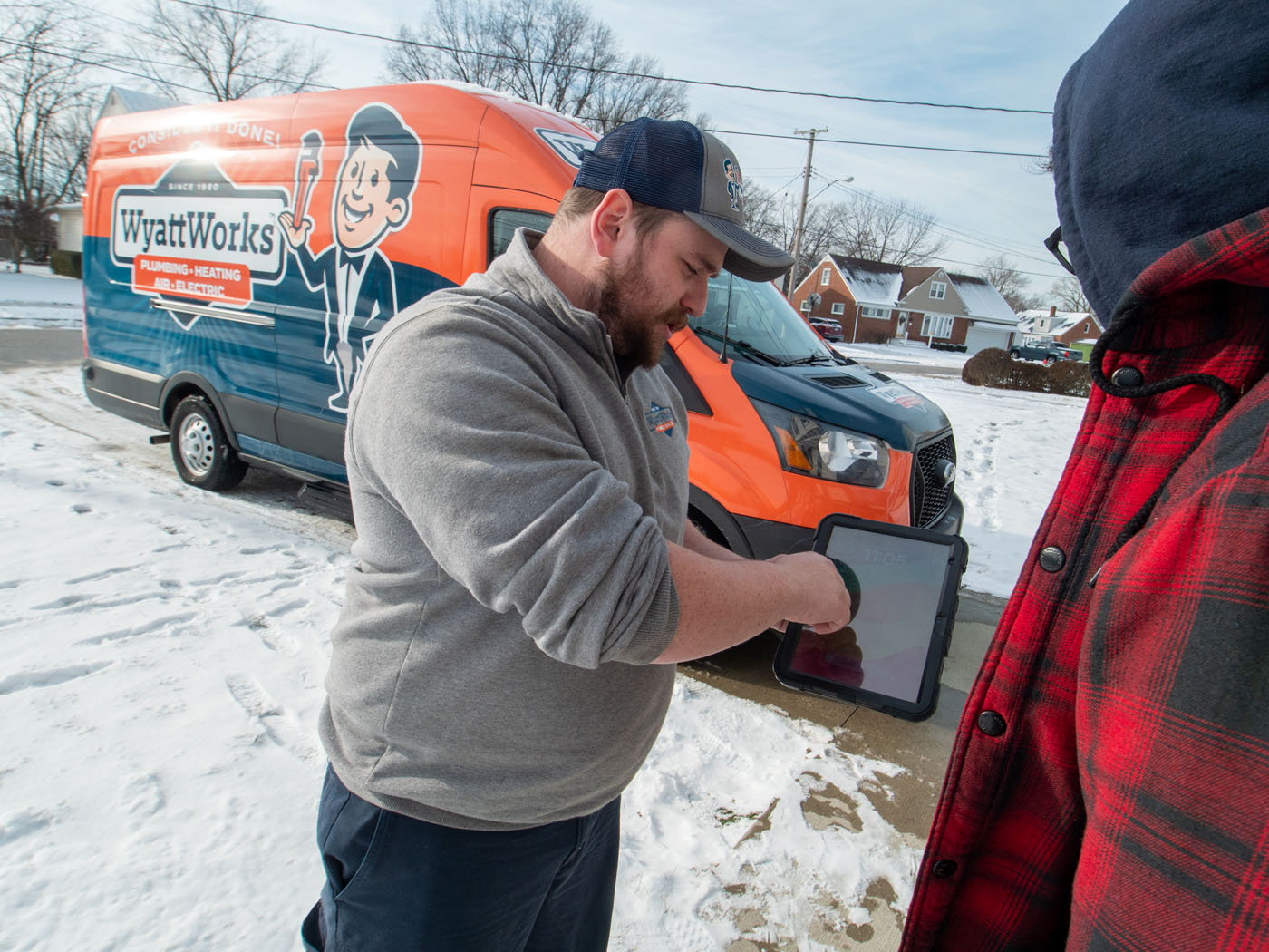 A WyattWorks technician breaking down service pricing and estimates for a customer in Ohio & North Carolina.