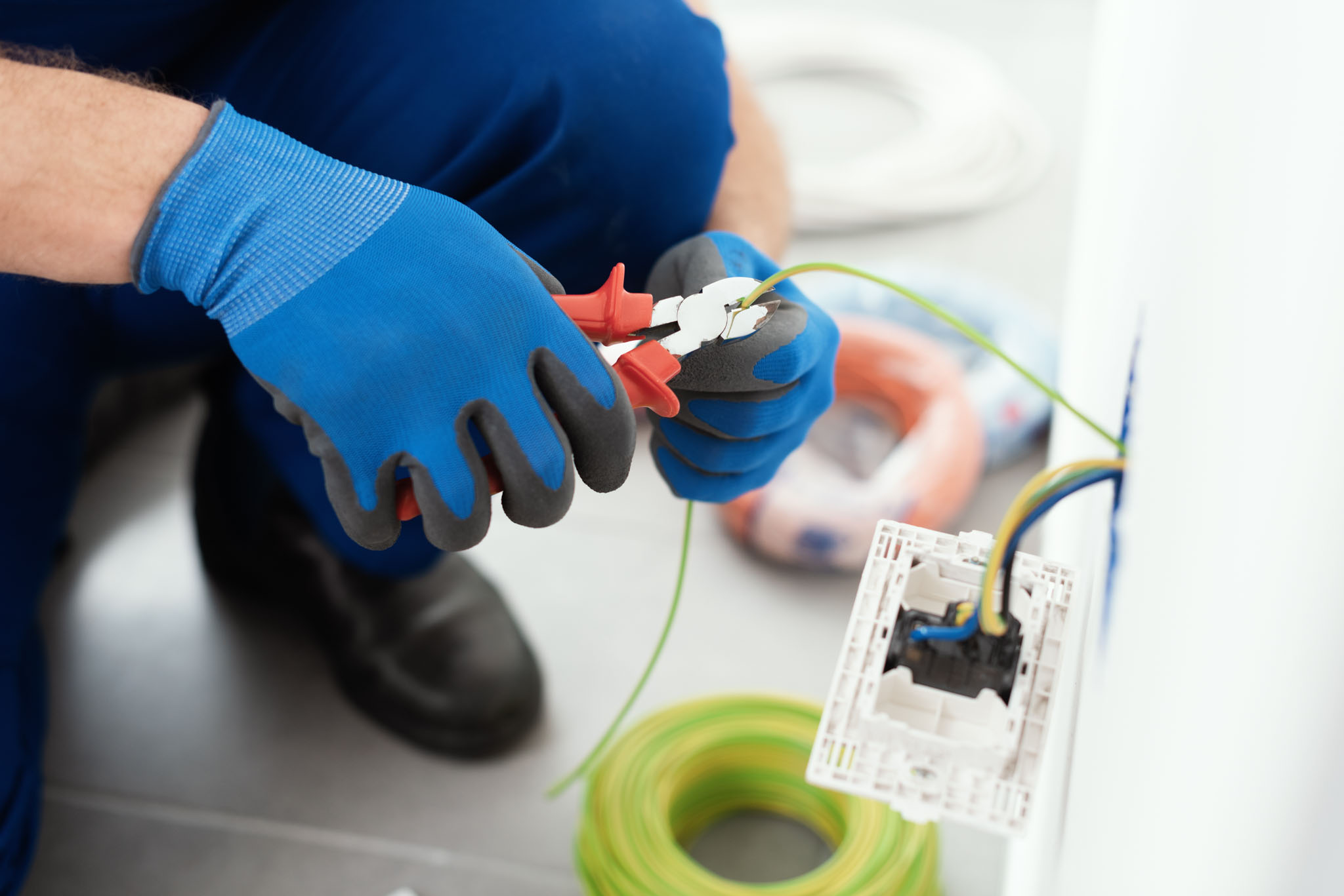 An electrician working on faulty wiring - Parma / Seven Hills electric repair company, WyattWorks.