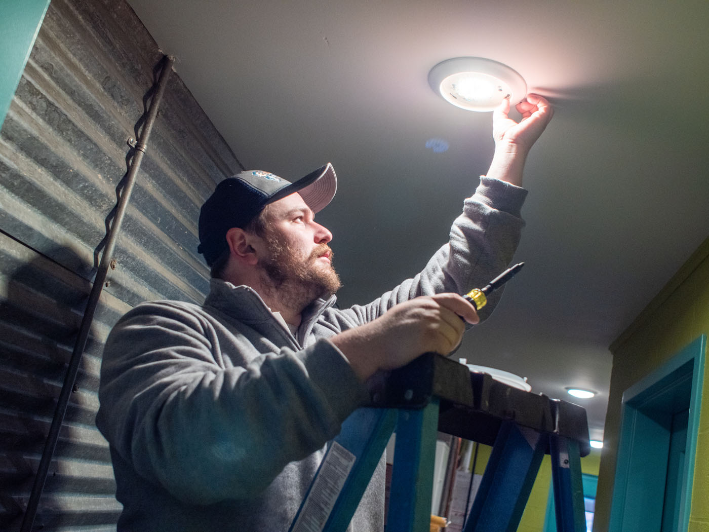 A WyattWorks local electrician in Seven Hills, OH working on a lighting fixture.