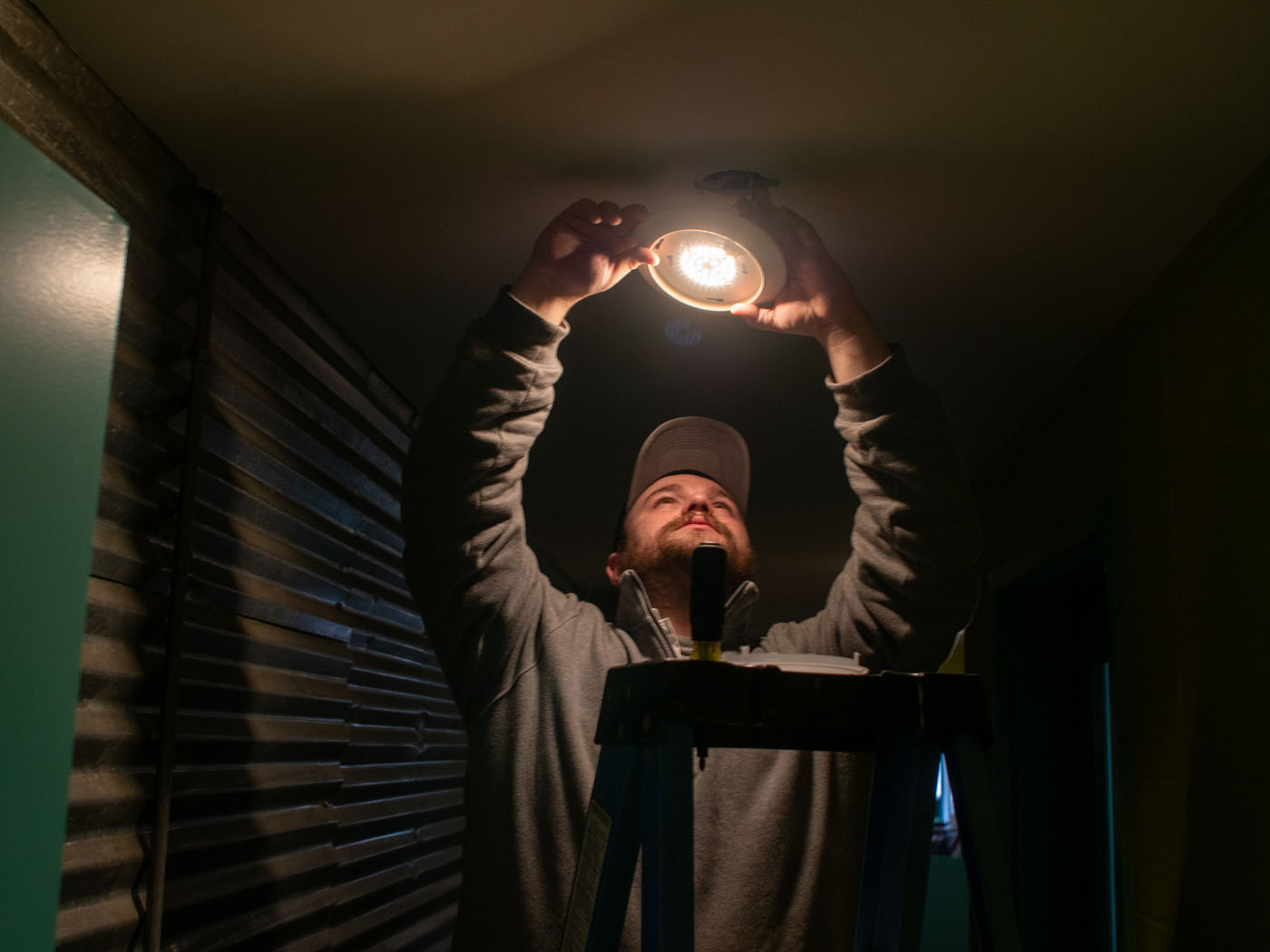 An image of a WyattWorks team member changing a lightbulb.