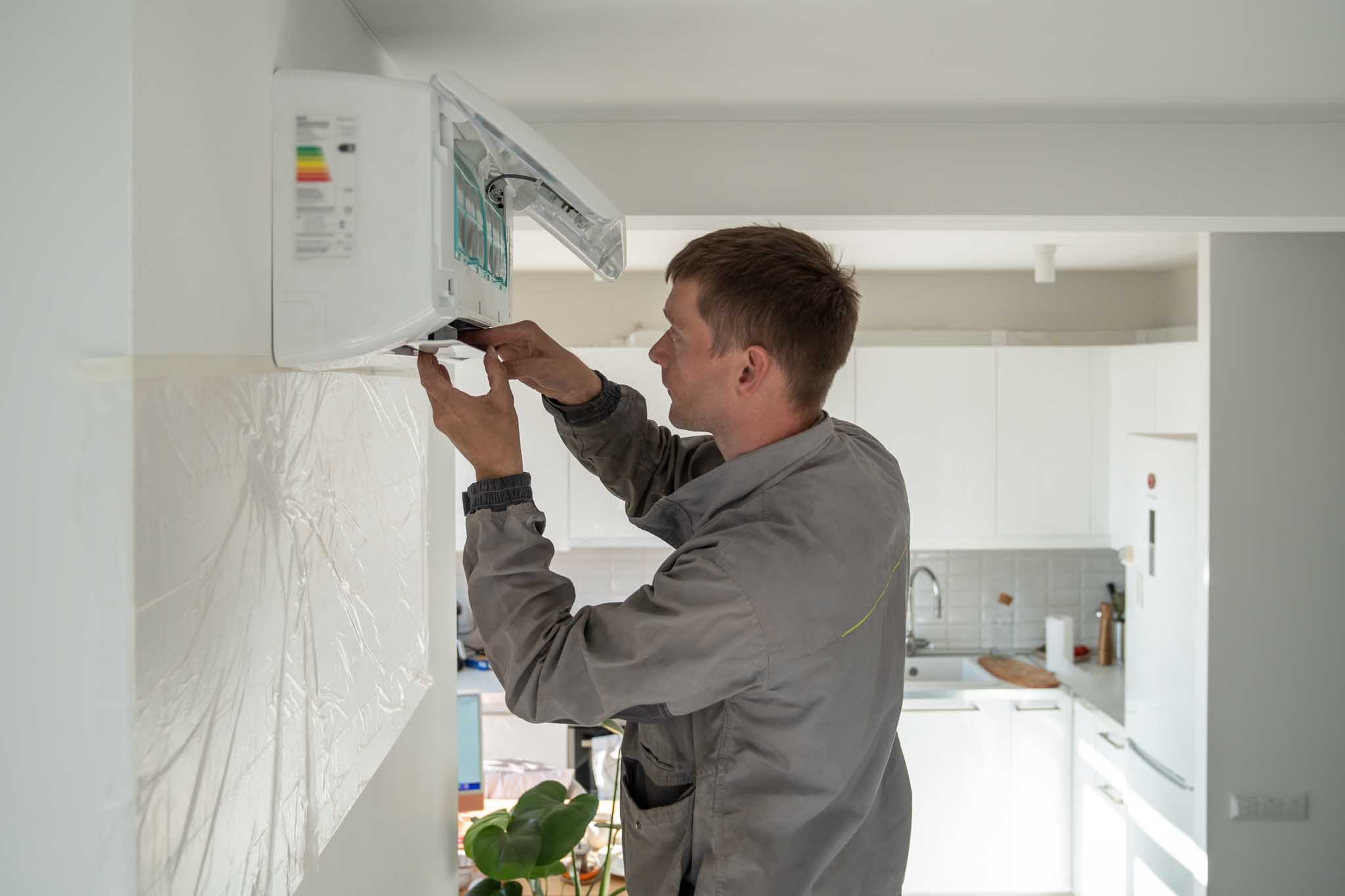 An HVAC tecnician installing a ductless system - contact WyattWorks today for professional HVAC services in Parma / Seven Hills, OH.