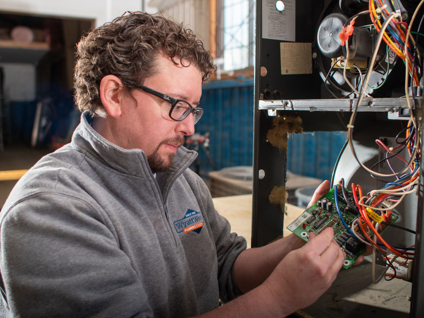 A WyattWorks technician from our heating company in Ohio & North Carolina working on the electrical components from a furance system.