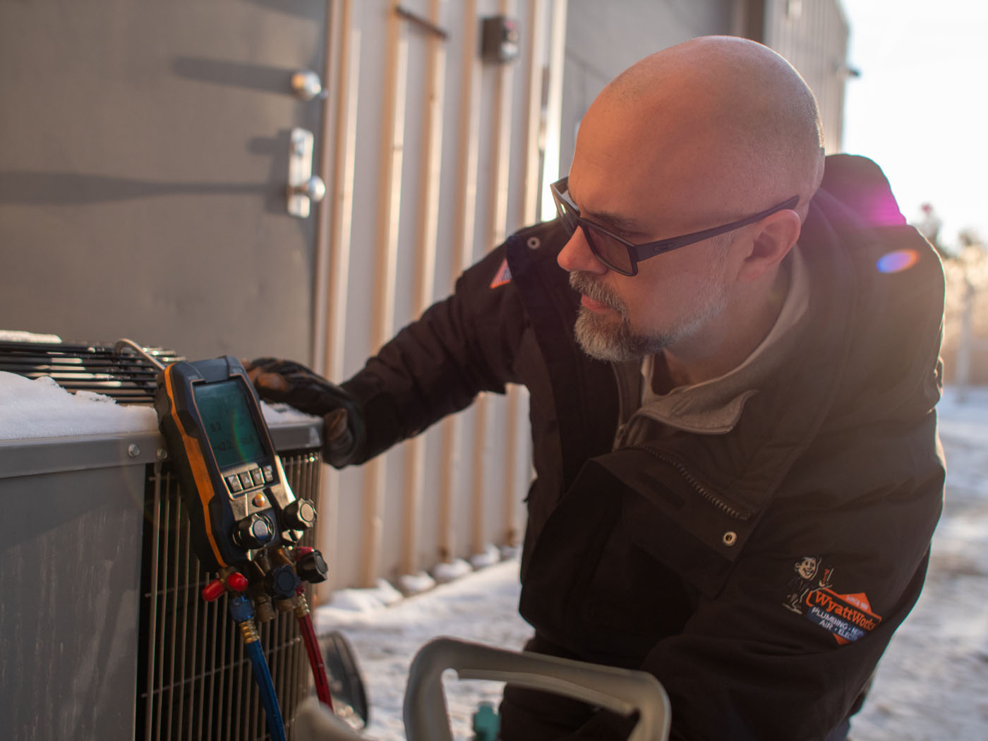 A WyattWorks technician performing an air conditioner service in Ohio & North Carolina.
