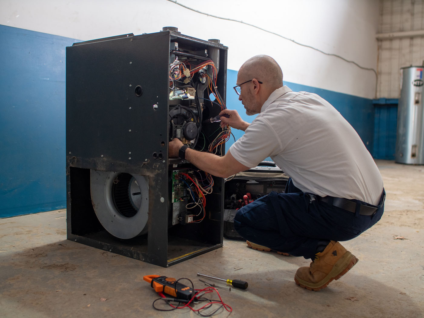 A WyattWorks technician providing HVAC services in Ohio & North Carolina on a heating system.