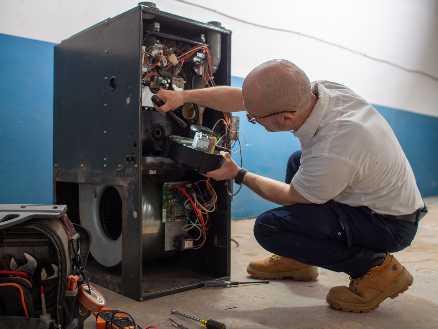 A WyattWorks professional working on a furnace.