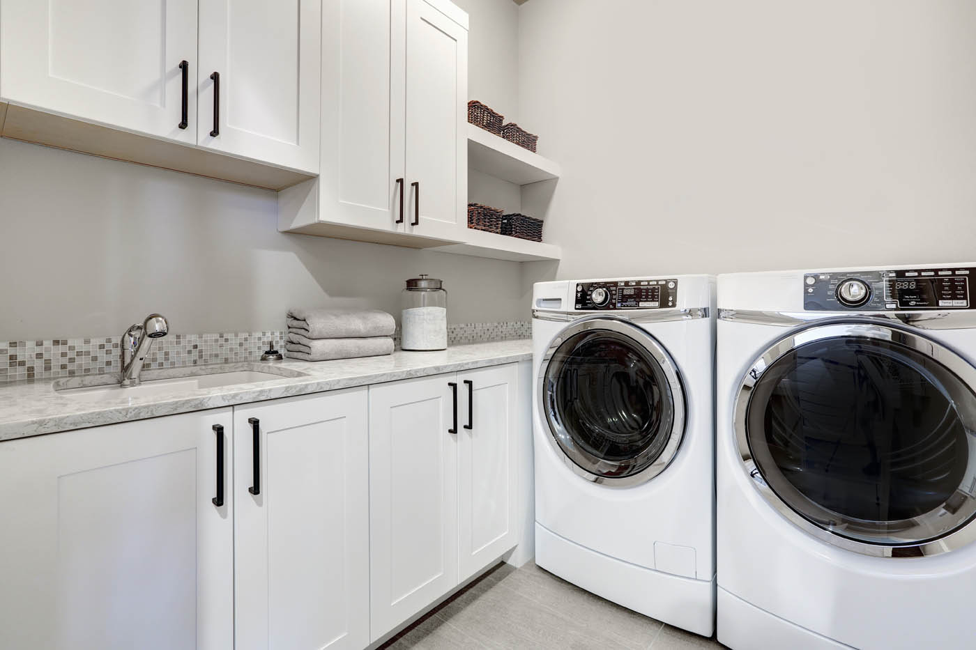 A laundry room with washing machine drain plumbing in Huntersville, NC performed by WyattWorks.