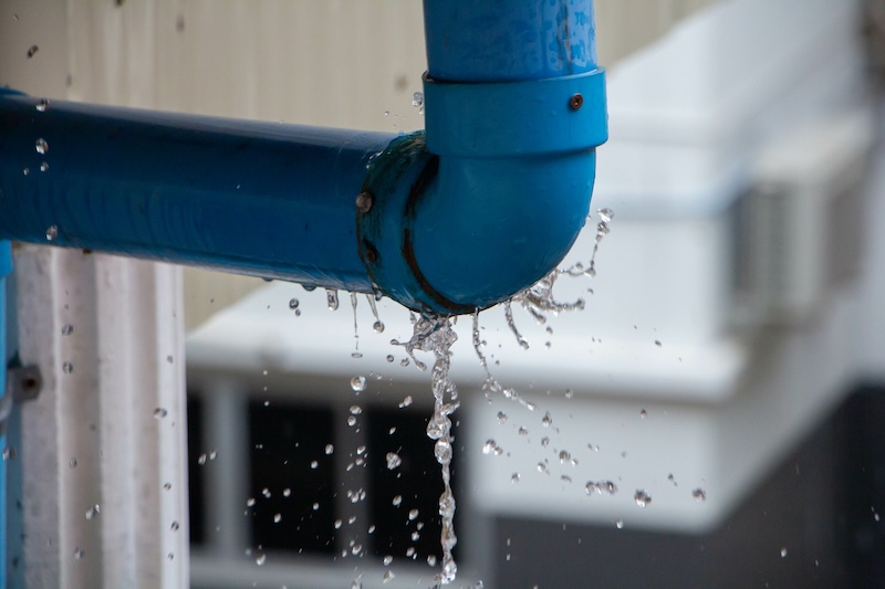 A pipe leak in a laundry room - contact WyattWorks for expert repairs!