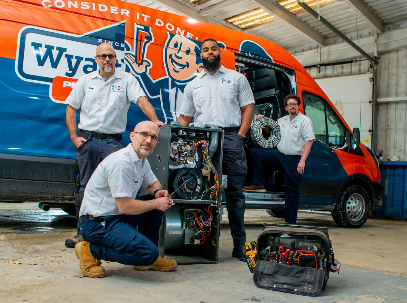 The WyattWorks team posing in front of a company truck - one of the top plumbing and home service companies in Huntersville, NC.