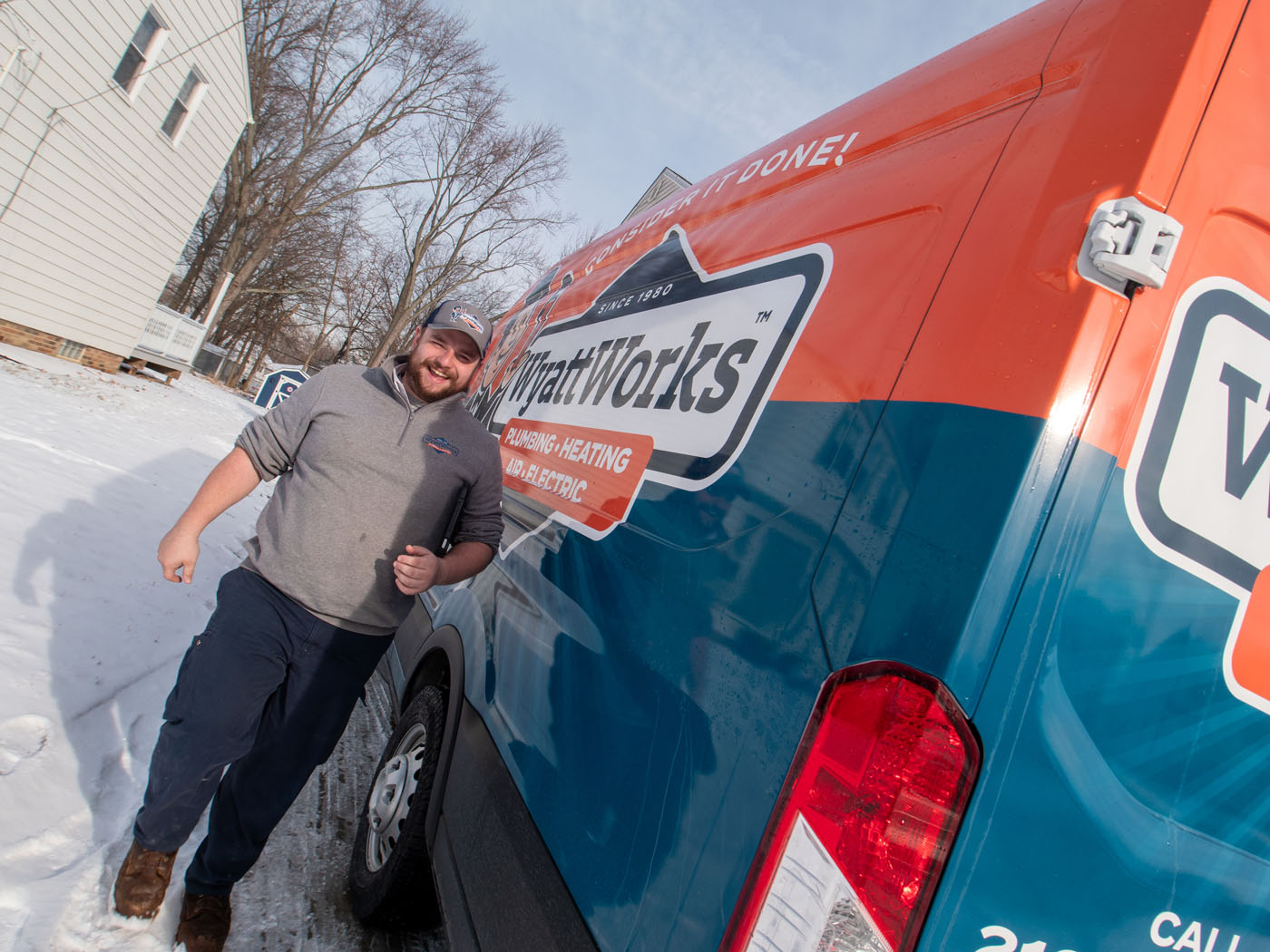 A WyattWorks Plumbing contractor outside of a branded van - call WyattWorks, the top rooter plumbing in Ohio & North Carolina.